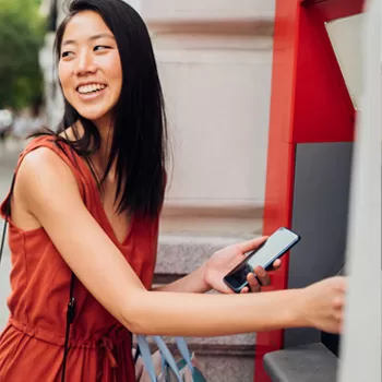 young woman using atm